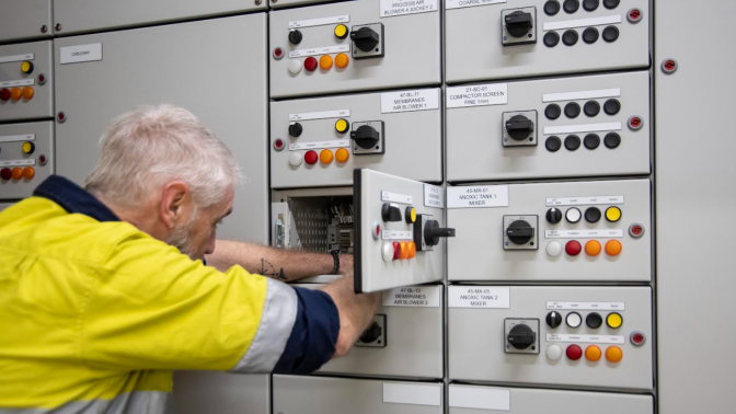 Kinetic Electrical technician working on an industrial switchboard