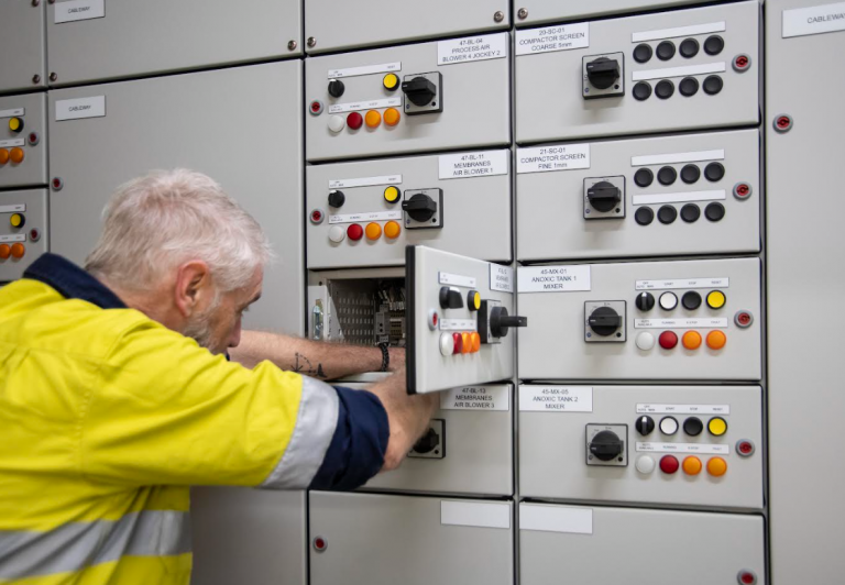 Kinetic Electrical technician working on an industrial switchboard